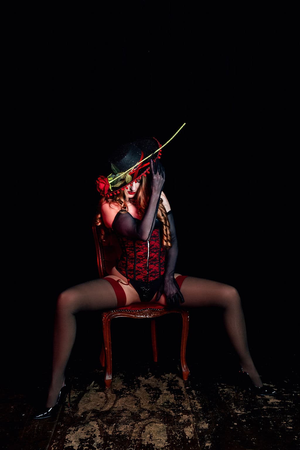 A cabaret performer on a chair.